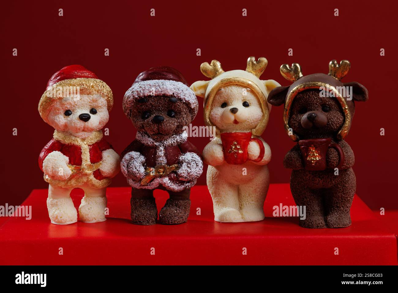Different christmas chocolate figures on red background Stock Photo