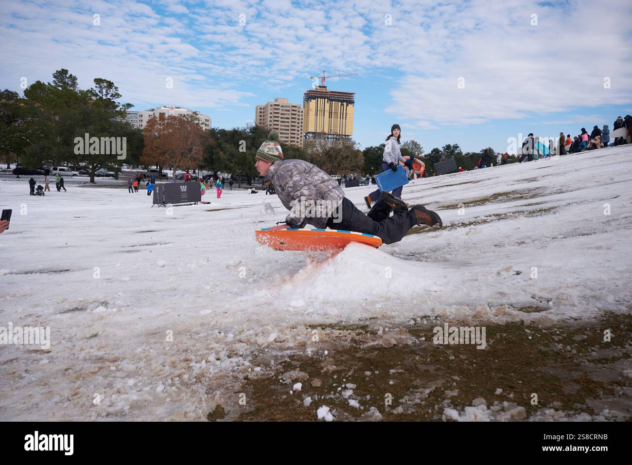 January 21, 2025, Houston, Texas, USA Residents play in the snow at