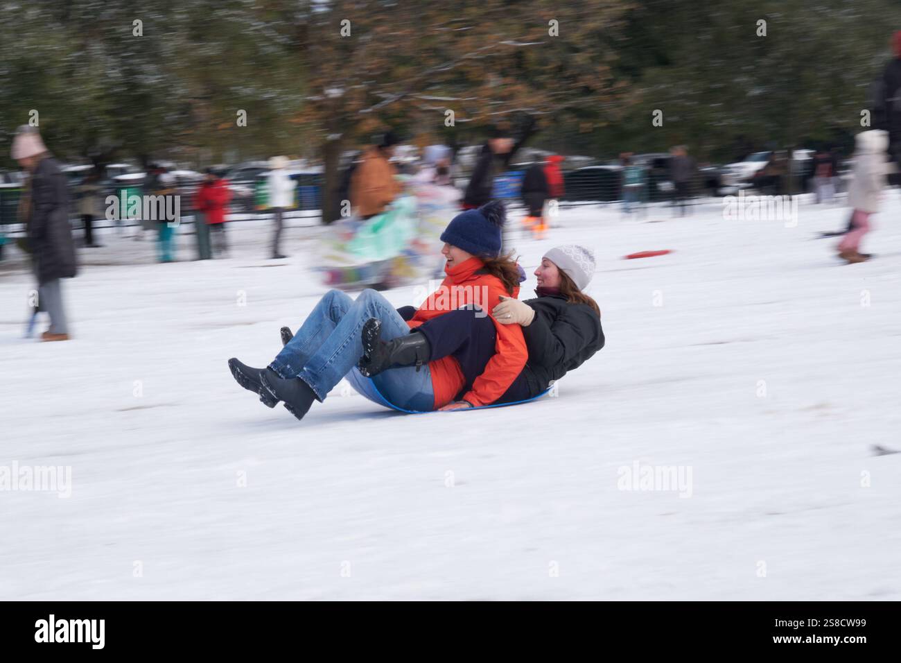 January 21, 2025, Houston, Texas, USA Residents play in the snow at