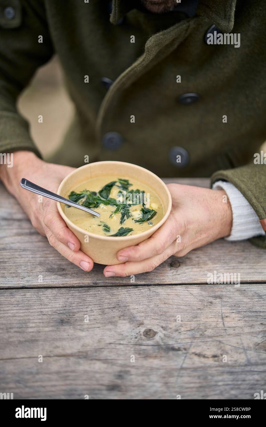 Winter celeriac and leek soup and flatbreads cooked over fire at the Hidden Hut cafe at Porthcurnick Beach, Cornwall, UK Stock Photo