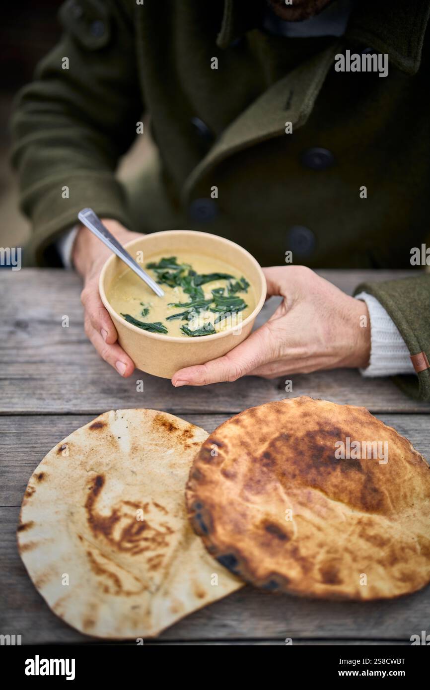 Winter celeriac and leek soup and flatbreads cooked over fire at the Hidden Hut cafe at Porthcurnick Beach, Cornwall, UK Stock Photo