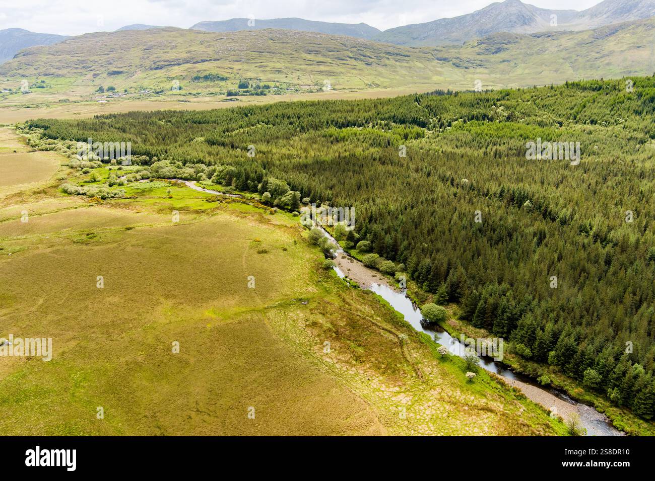 Aerial view of Joyce's river winding down below in Connemara region in ...