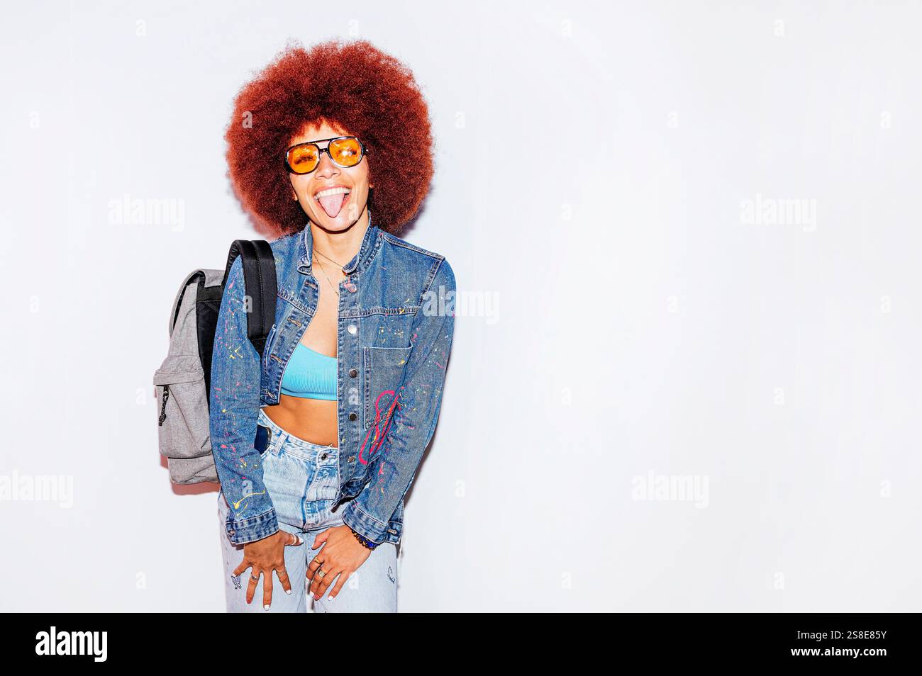 Joyful African descent woman with voluminous afro hair, sticking out ...