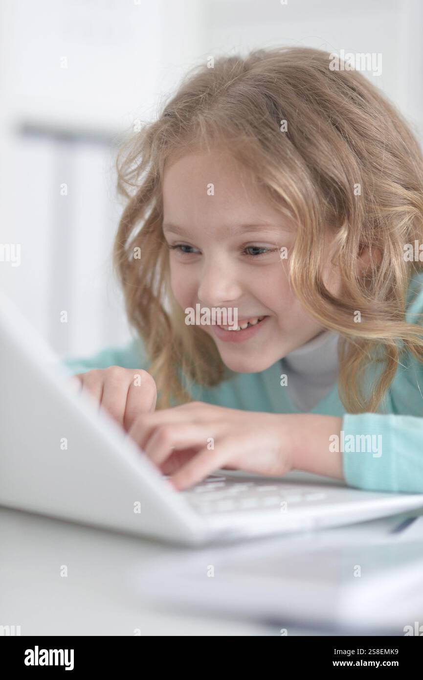 Cute and happy little girl children using laptop computer Stock Photo ...