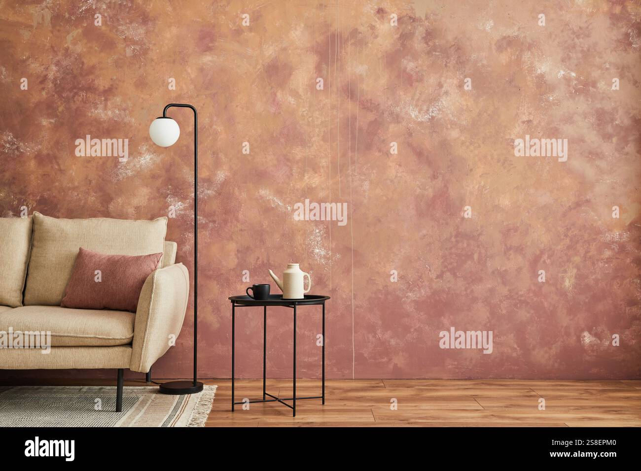 Stylish composition of modern minimalist living room interior. Beige sofa, metal side table and personal accessories. Creative wallpaper. Home staging Stock Photo