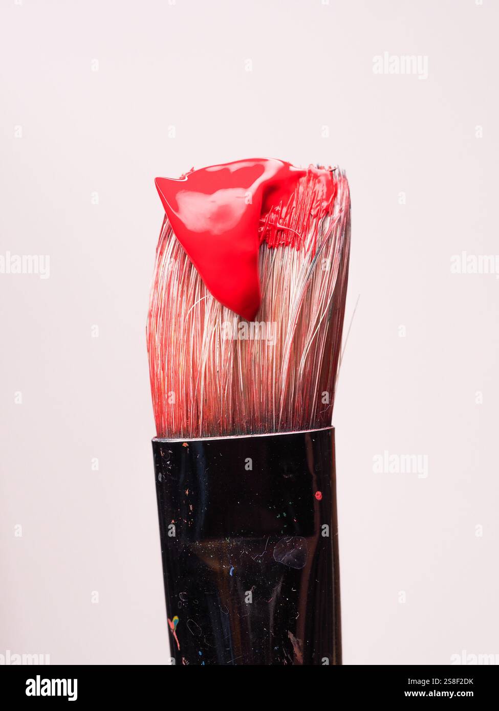 Paintbrush with red paint on a white background Stock Photo