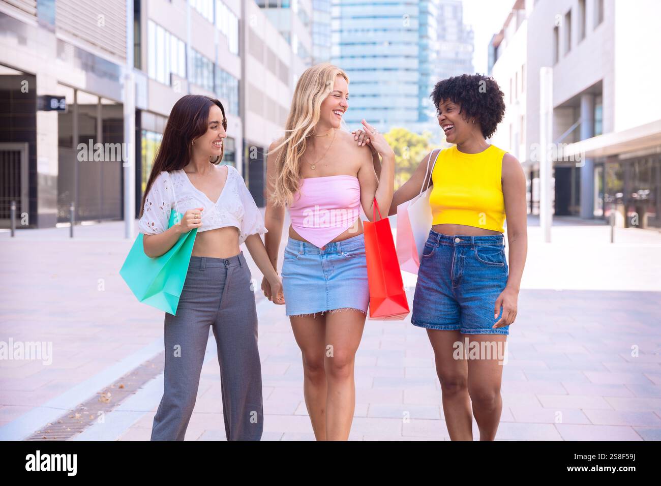Three Happy Women Shopping and Strolling Outdoors. Stock Photo