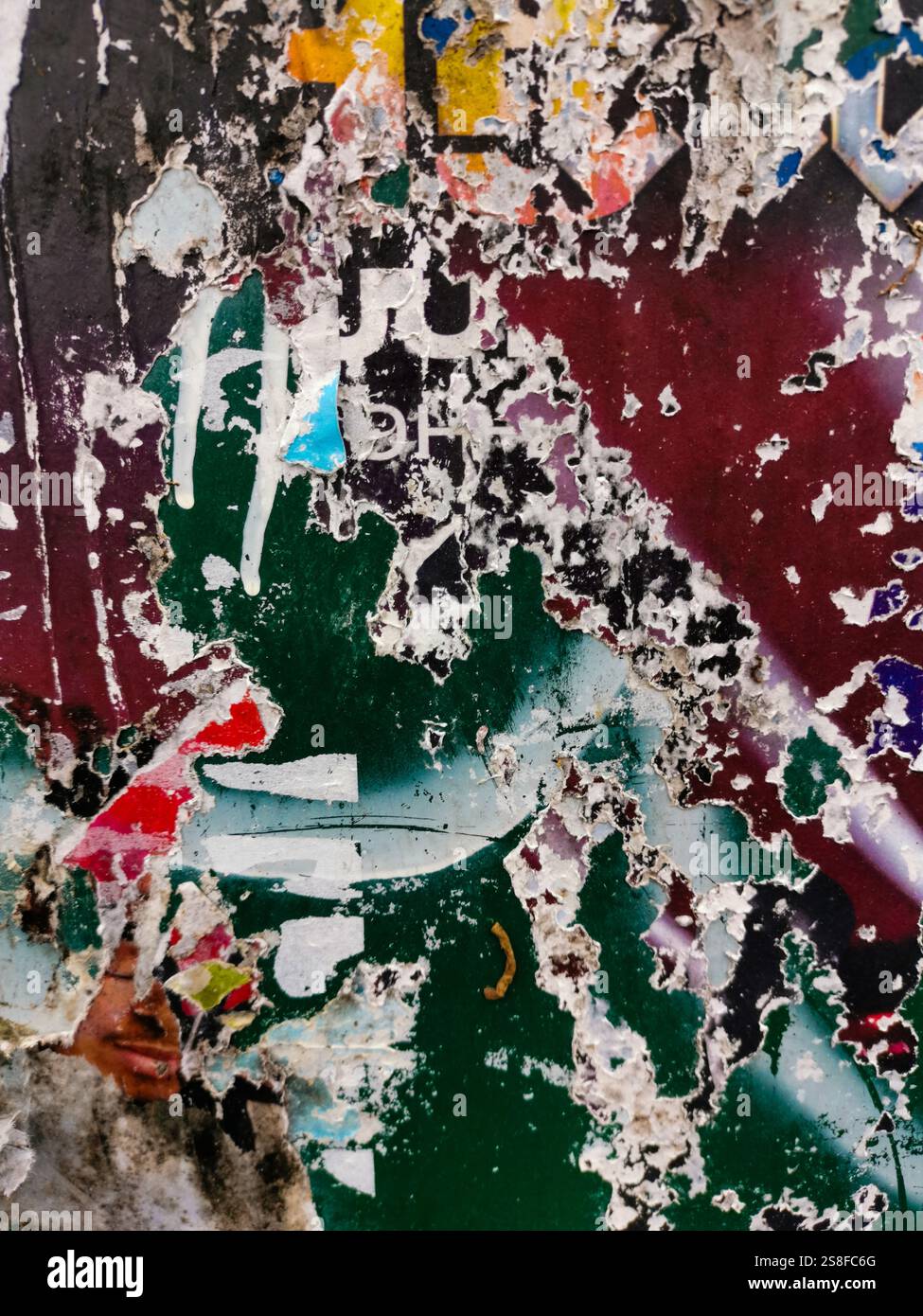 Urban wall art displaying layers of paint and weathered textures in an urban space - Smartphone Captured Stock Image