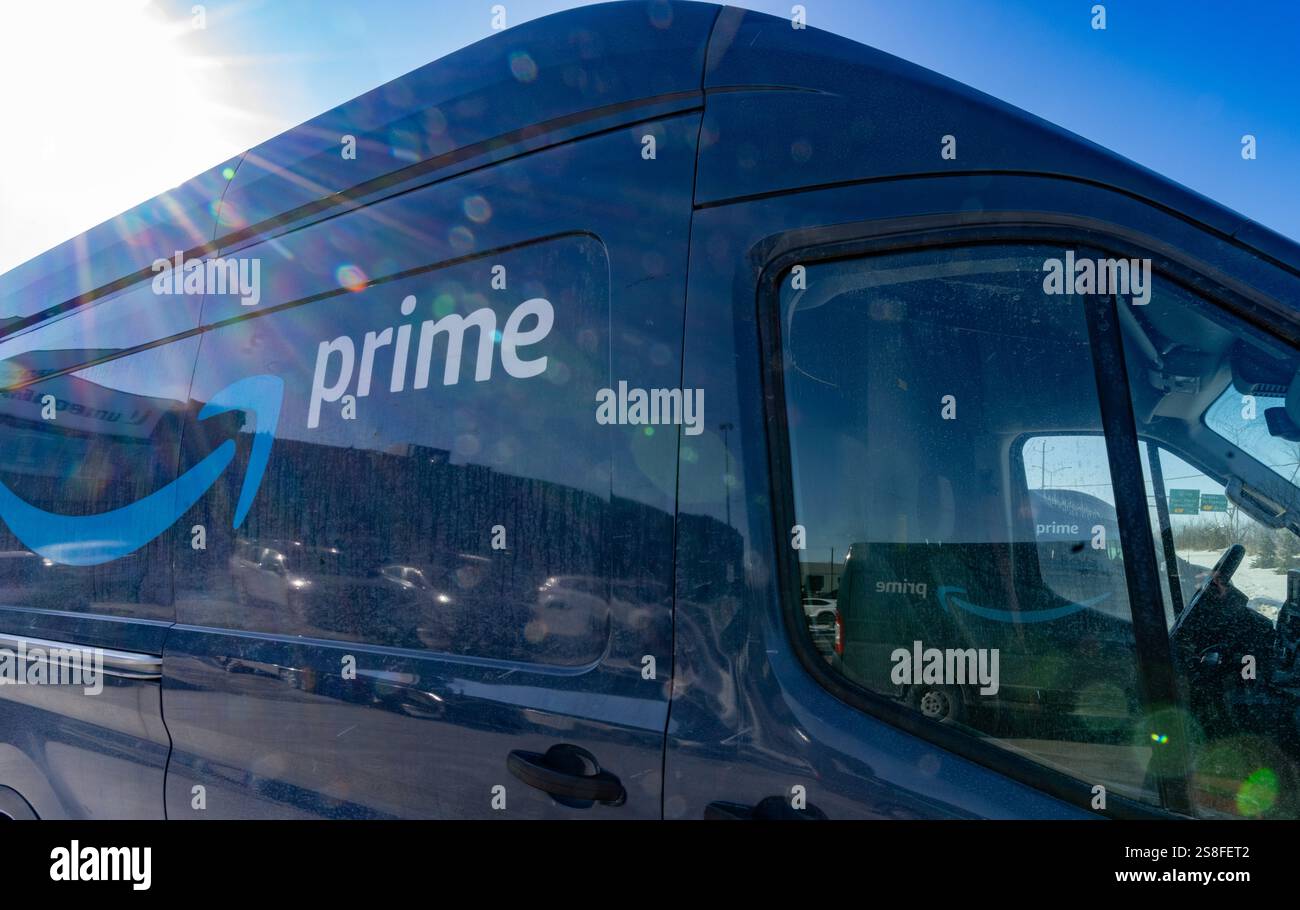 Delivery trucks are parked outside Amazon's DXT4 warehouse in Laval ...
