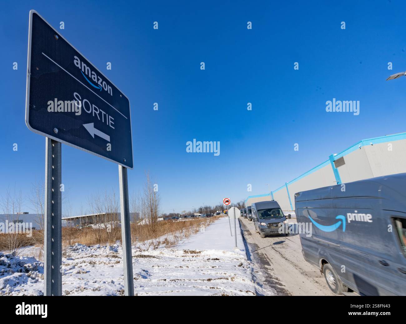 Amazon delivery trucks leave Amazon's DXT4 warehouse is seen in Laval ...