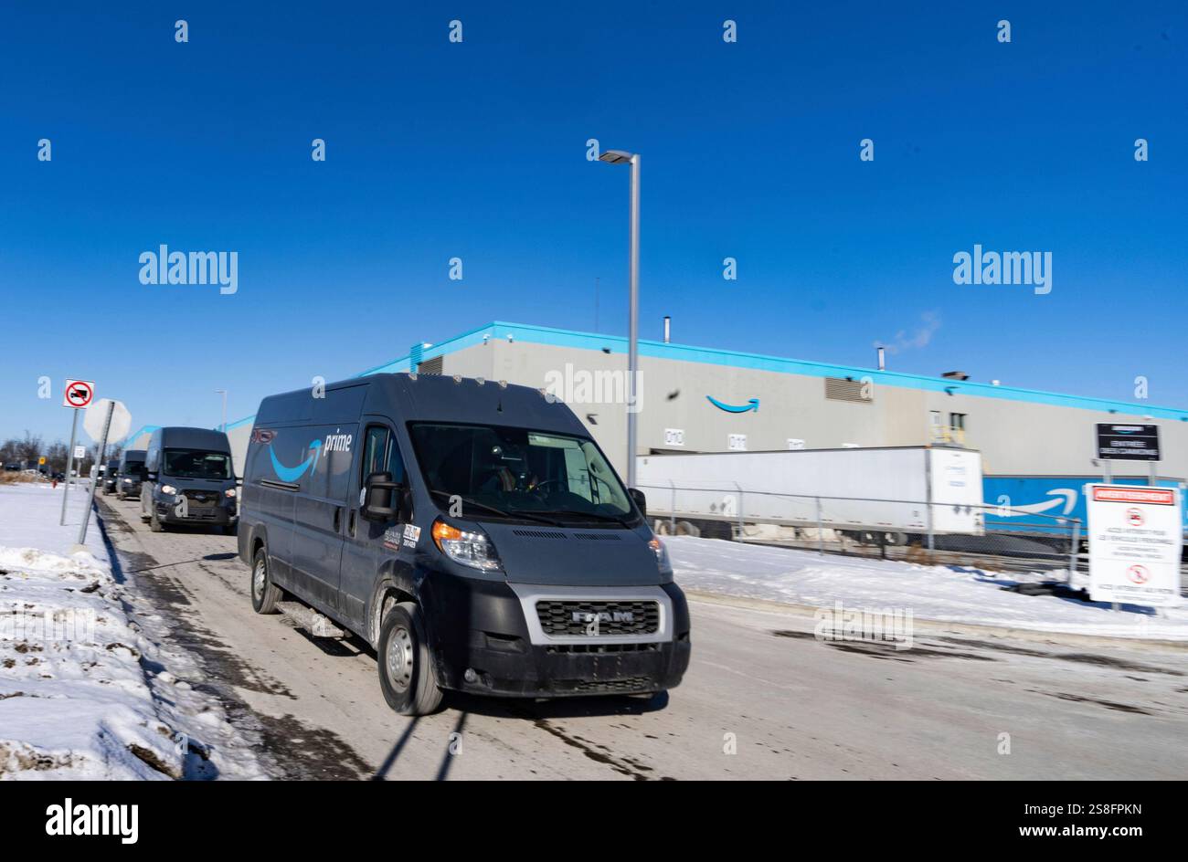 Amazon delivery trucks leave Amazon's DXT4 warehouse is seen in Laval ...