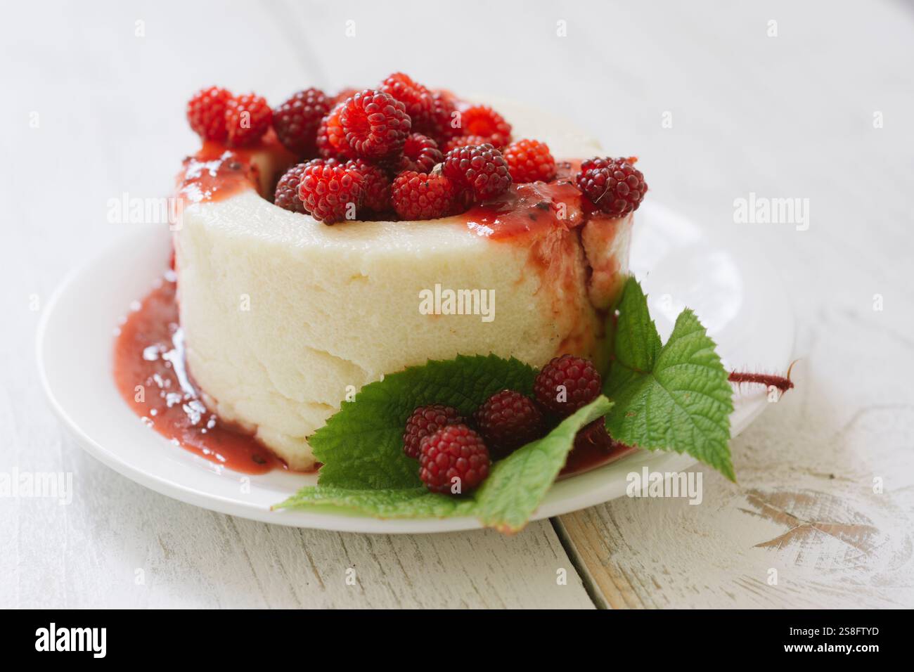 Home made semolina pudding with Japanese wineberries. Stock Photo