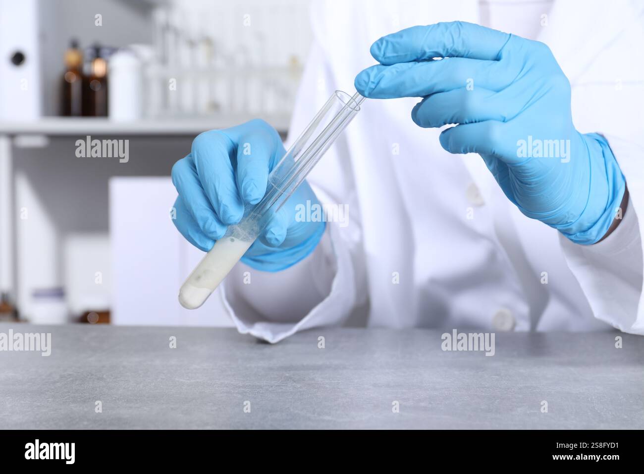 Sample Taker Lab Laboratory testing. Scientist taking sample from test tube at grey ...