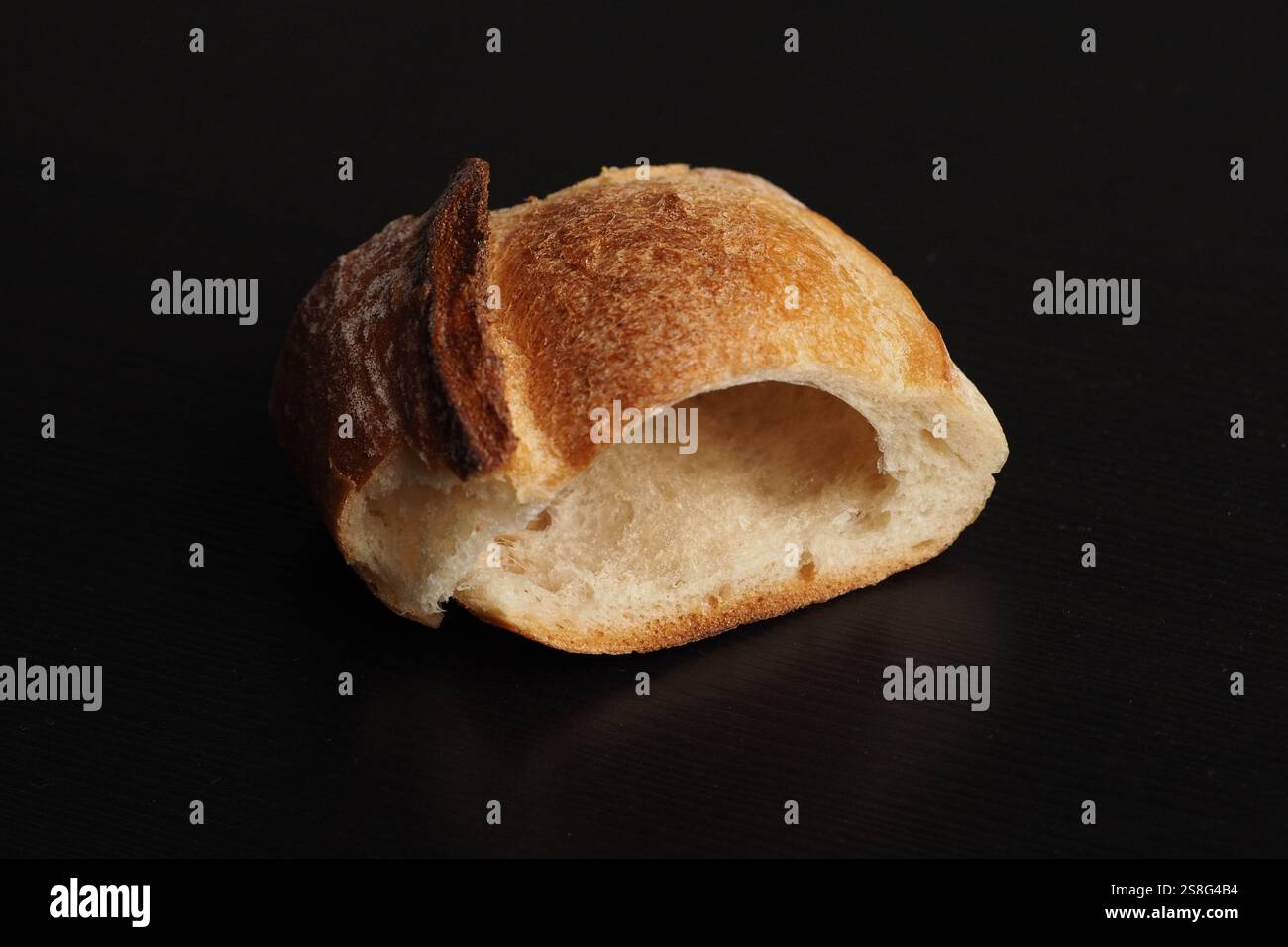 Baked bread roll with a golden crust empty inside Stock Photo - Alamy