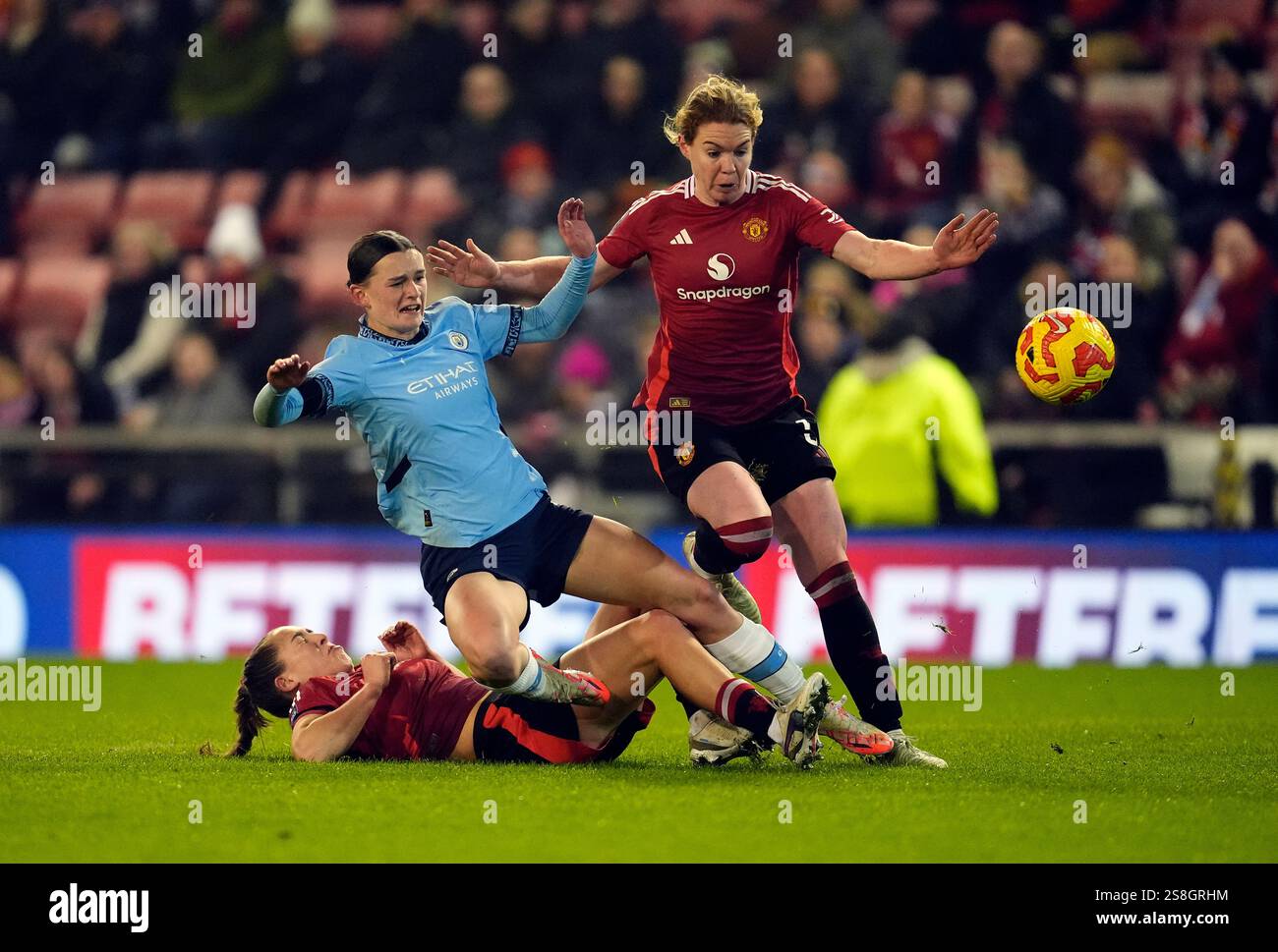 Manchester United's Maya Le Tissier slides in on Manchester City's Lily