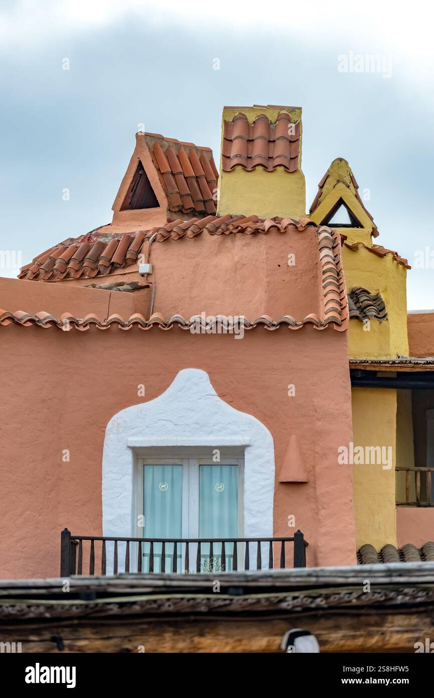 colorful, brown-yellow house facade with windows and interlocking roof ...