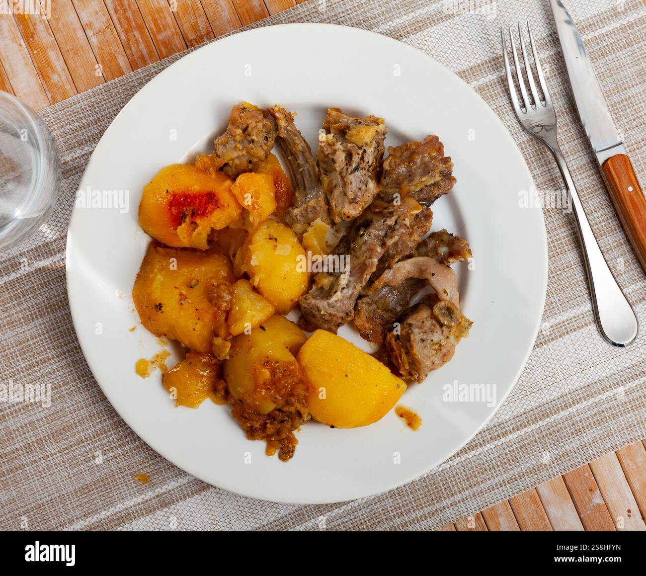 Braised rabbit served with potato garnish Stock Photo