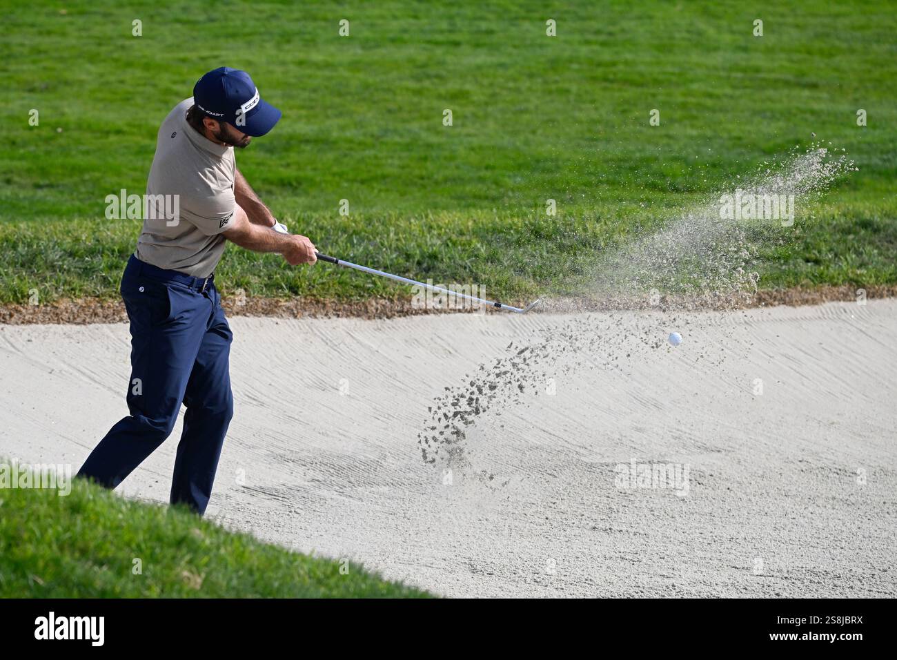 Max Homa hits out of the bunker on the first hole of the South Course
