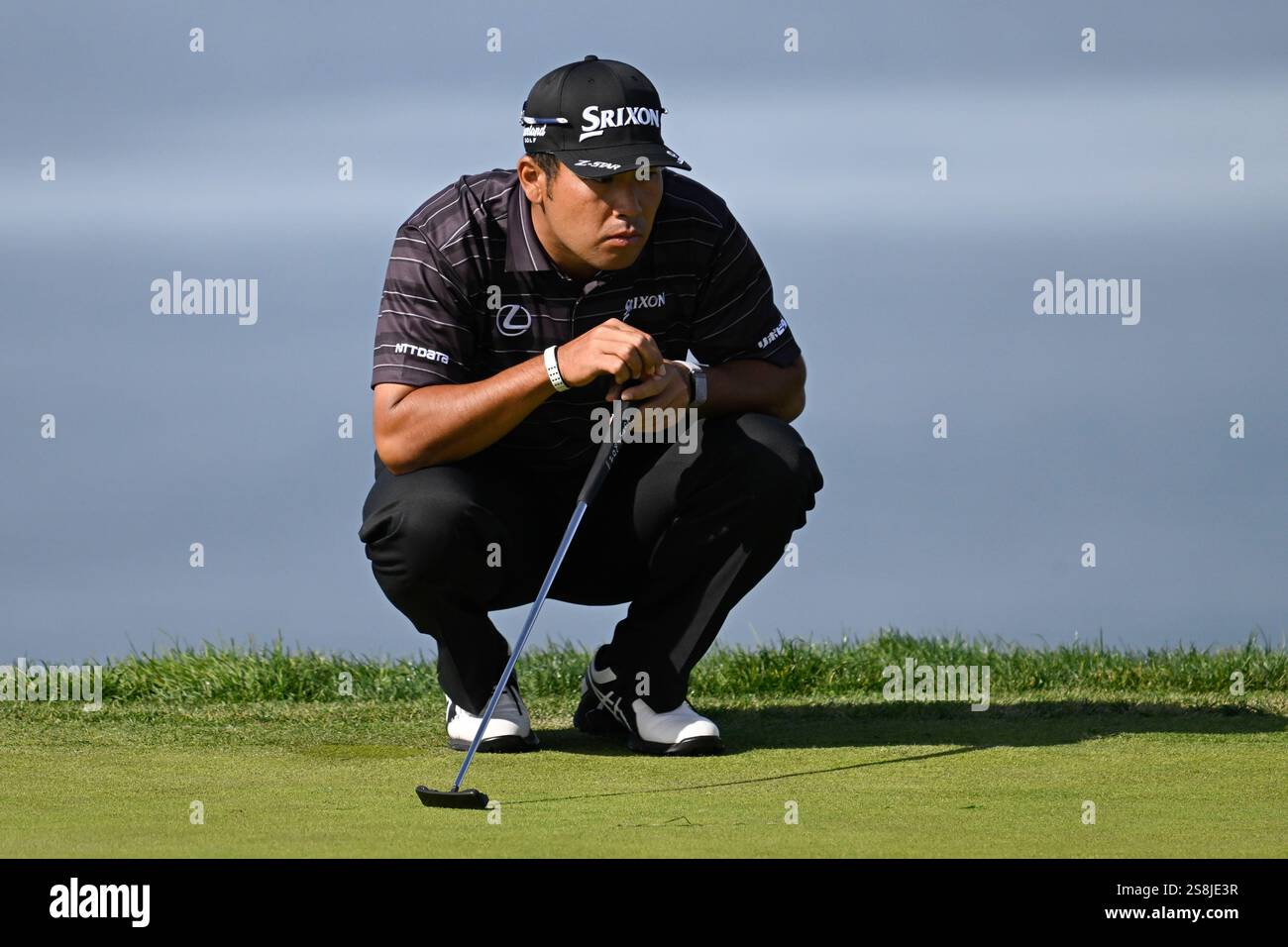 Hideki Matsuyama lines up a putt on the fourth hole of the South Course