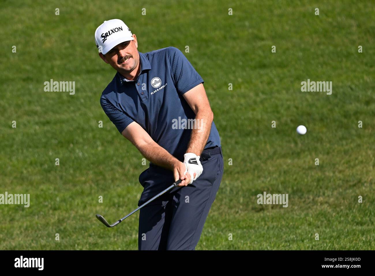 Kegan Bradley hits out of the rough on the eighth hole of the North