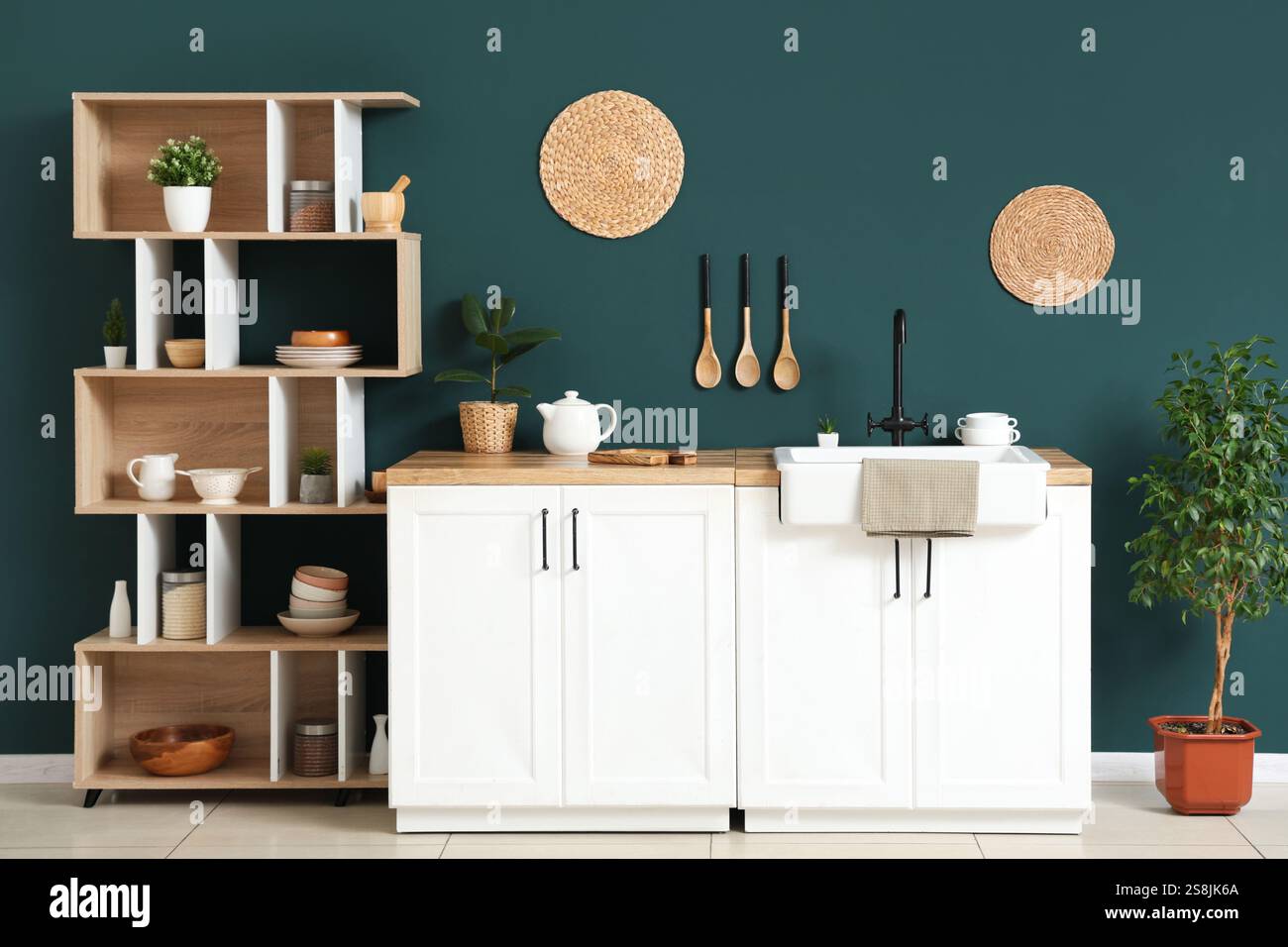 Interior of light kitchen with shelving unit and white counters near ...