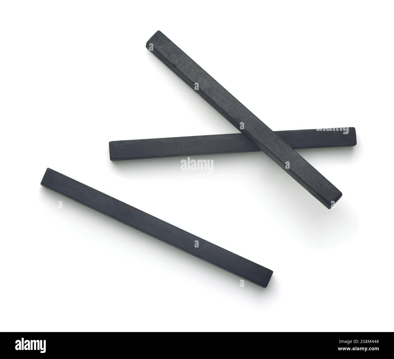 Top view of compressed charcoal drawing sticks isolated on white Stock Photo