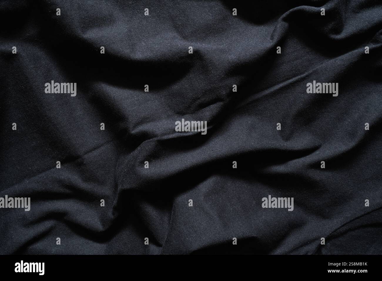 Deep Black Fabric with Dramatic Drapes and Shadows Stock Photo