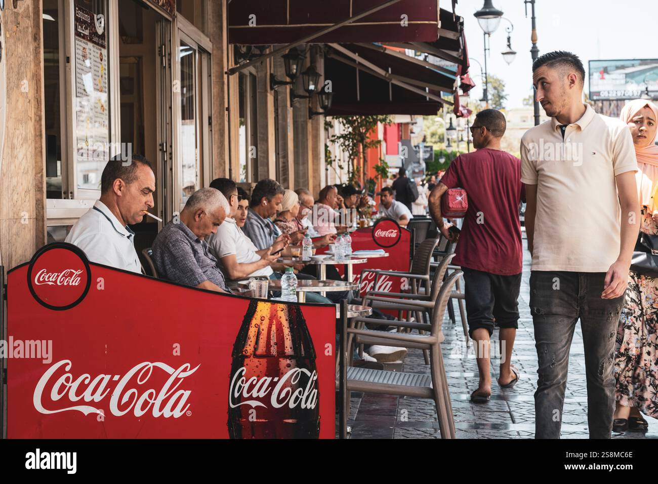 Tangier, Morocco. Moroccan people taking a break and drinking a cup of coffee or a mint tea. Exterior view of a traditional bar. Stock Photo