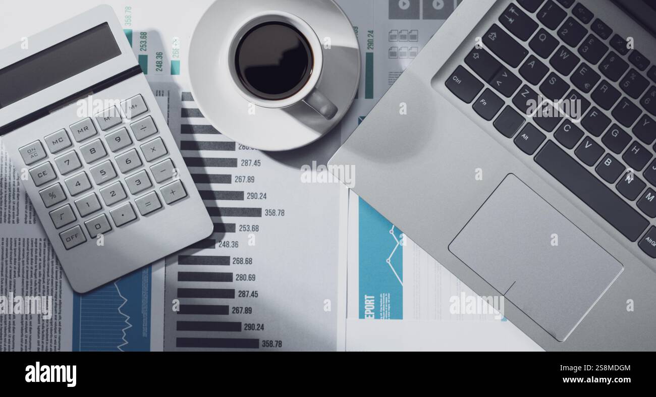 Corporate office desktop with many financial charts, business report ...