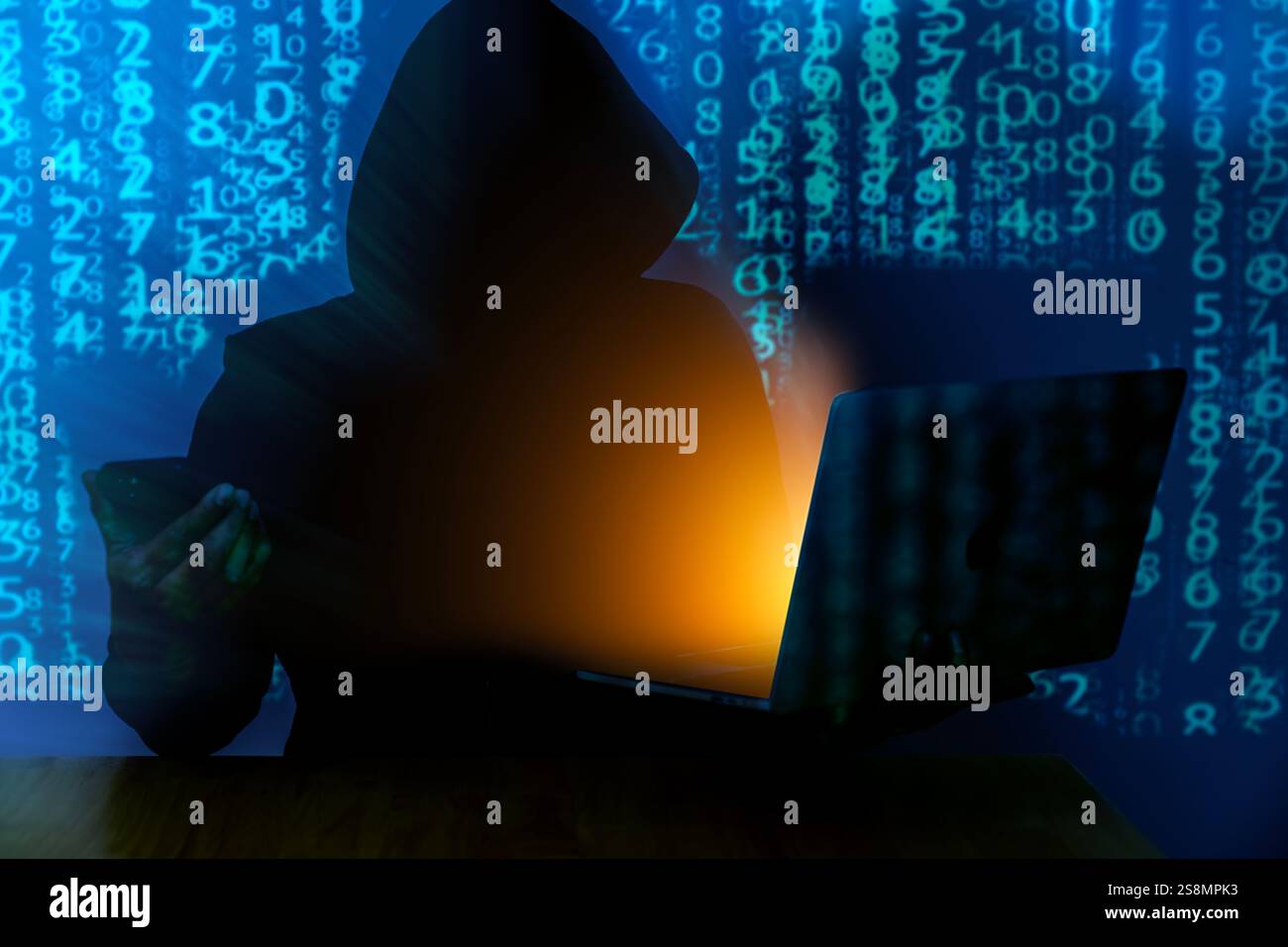 Computer hacker stealing data from a laptop Stock Photo