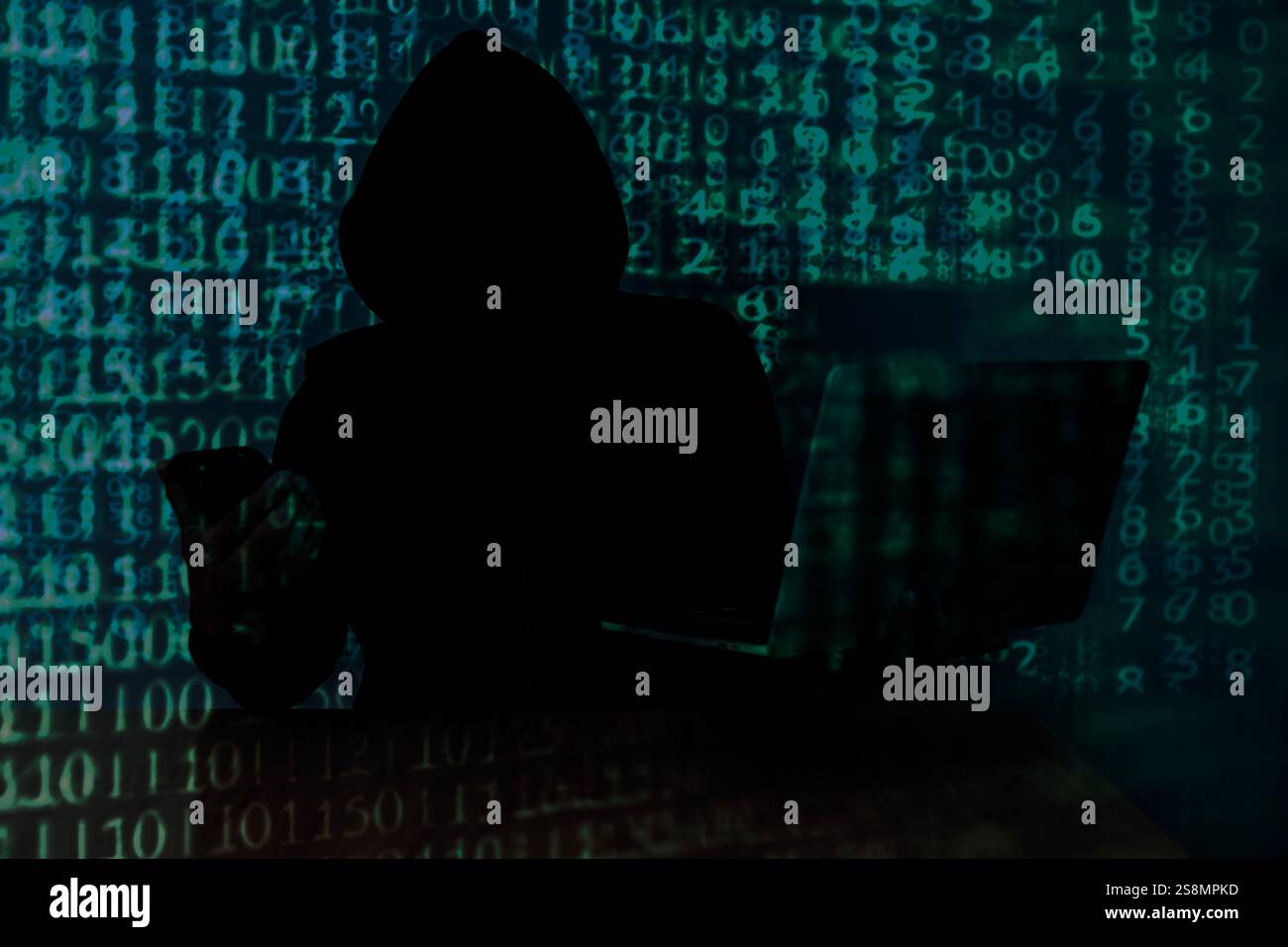 Computer hacker stealing data from a laptop Stock Photo