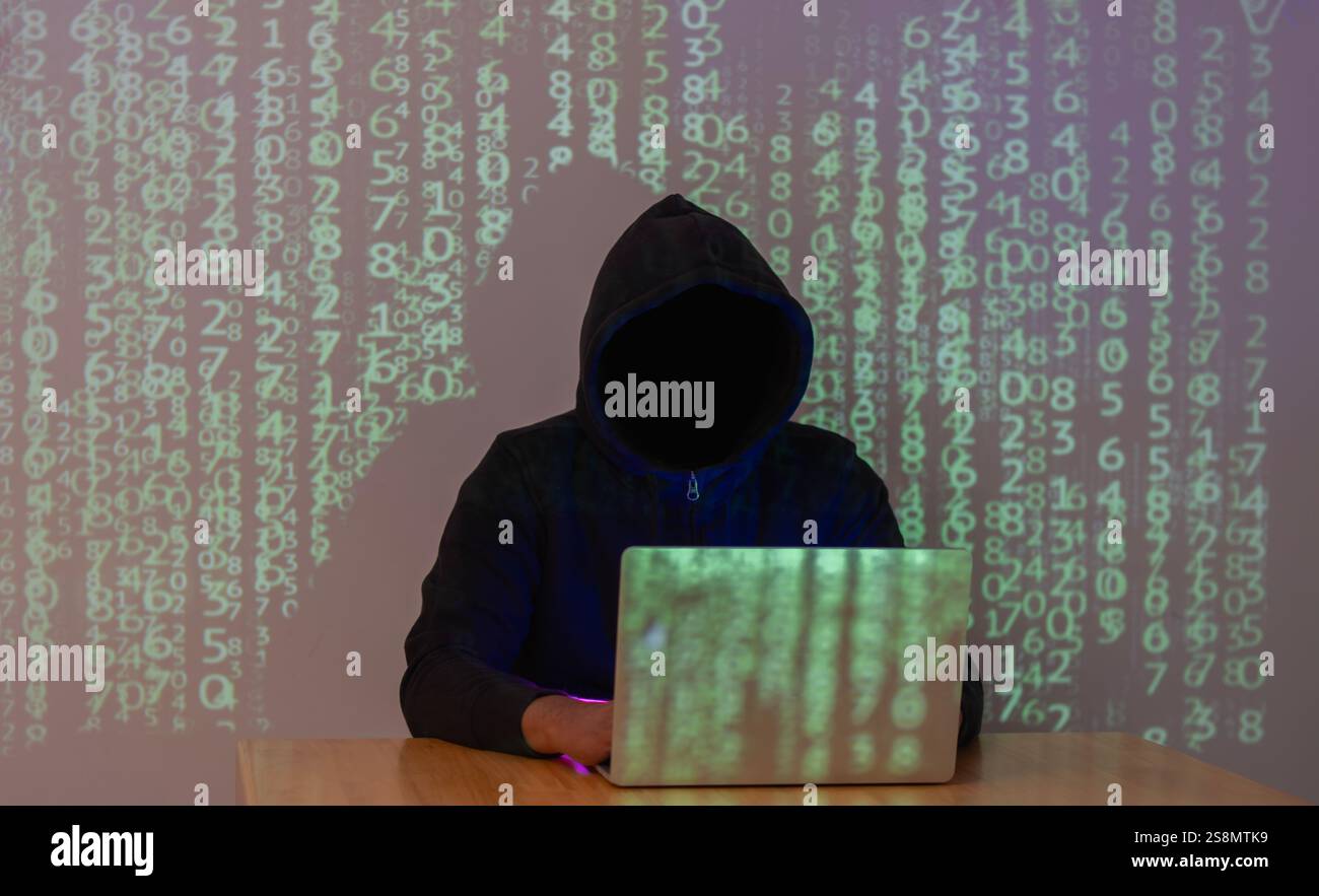 Hacking and malware concept. Hacker using abstract laptop  with binary code digital on background. Stock Photo