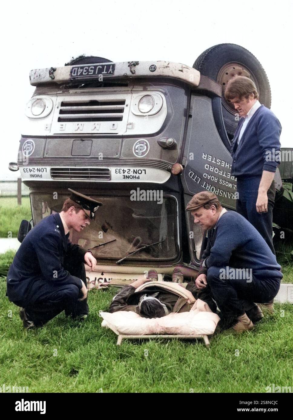 Man Over Driver A police officer and two men comfort an injured driver in front of his ...