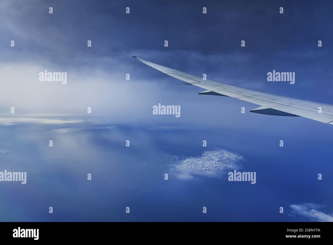 Blue sky, cloud structures over the Arabian Sea. View from the aircraft window during a flight from Phuket to Abu Dhabi with the airline Etihad. Wing Stock Photo