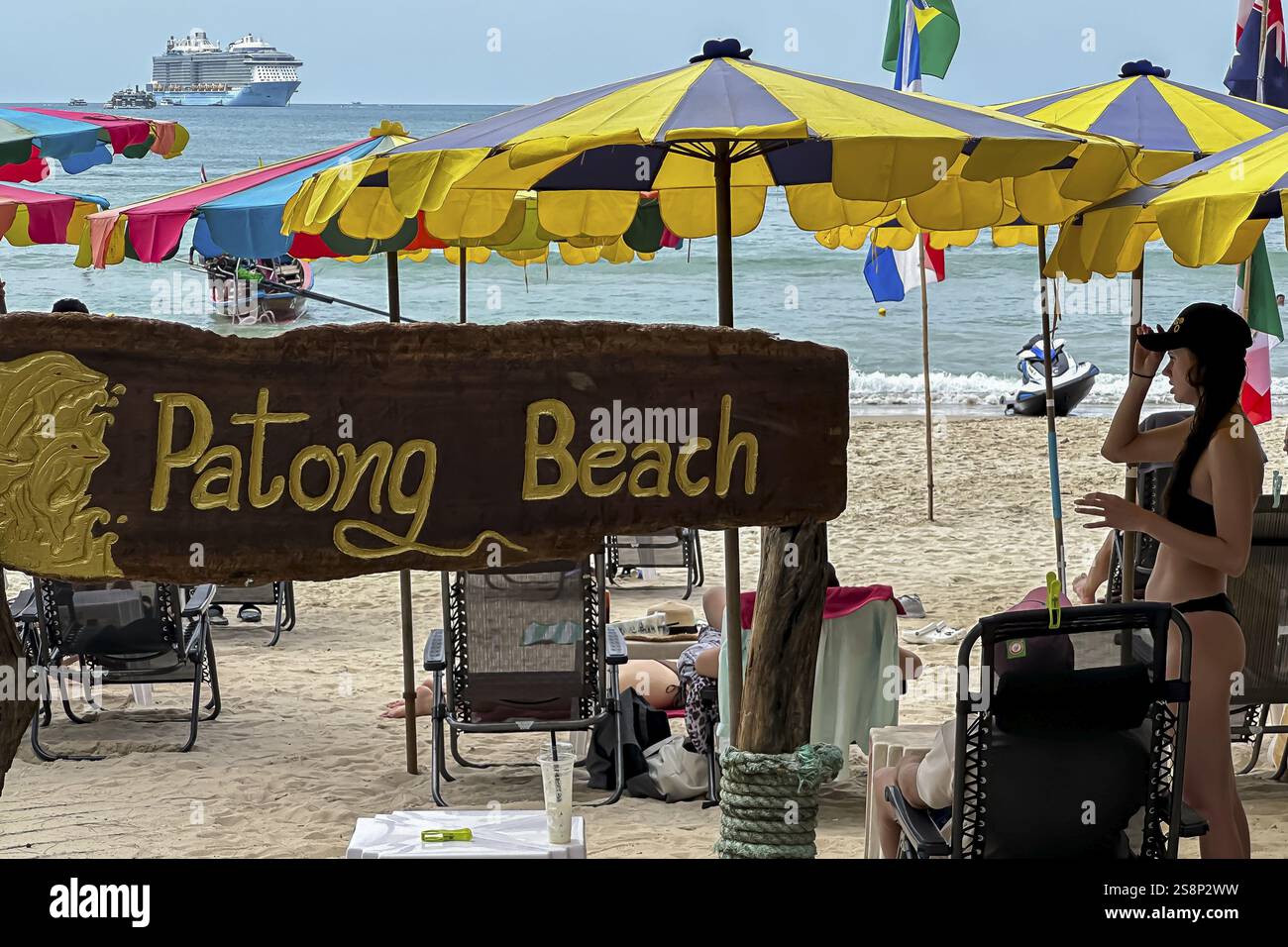 Patong beach on the Indian Ocean with parasol and cruise ship. Patong, Kathu, Phuket Island, Thailand, Asia Stock Photo