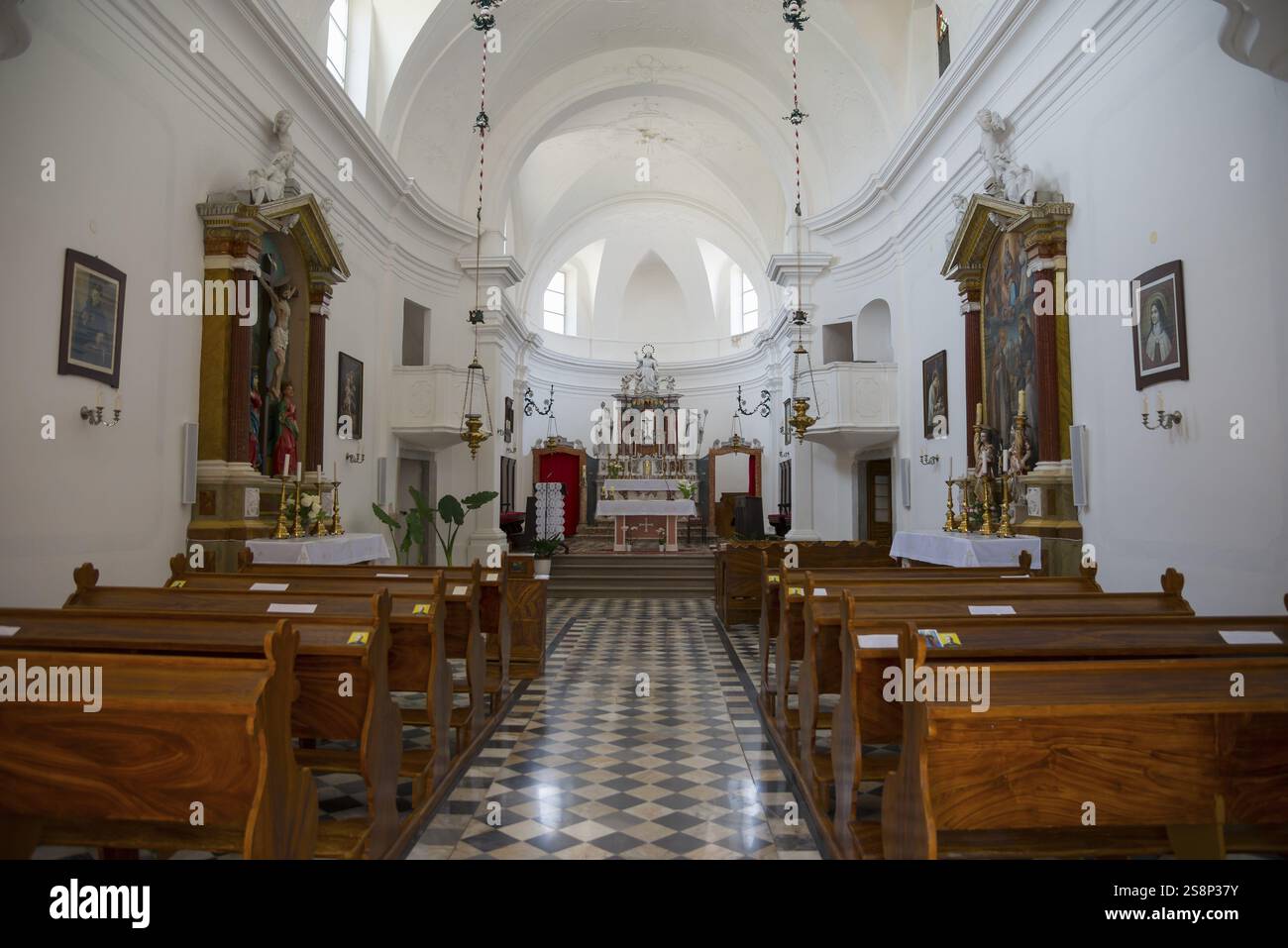 Bright church interior with wooden benches and magnificent altar ...