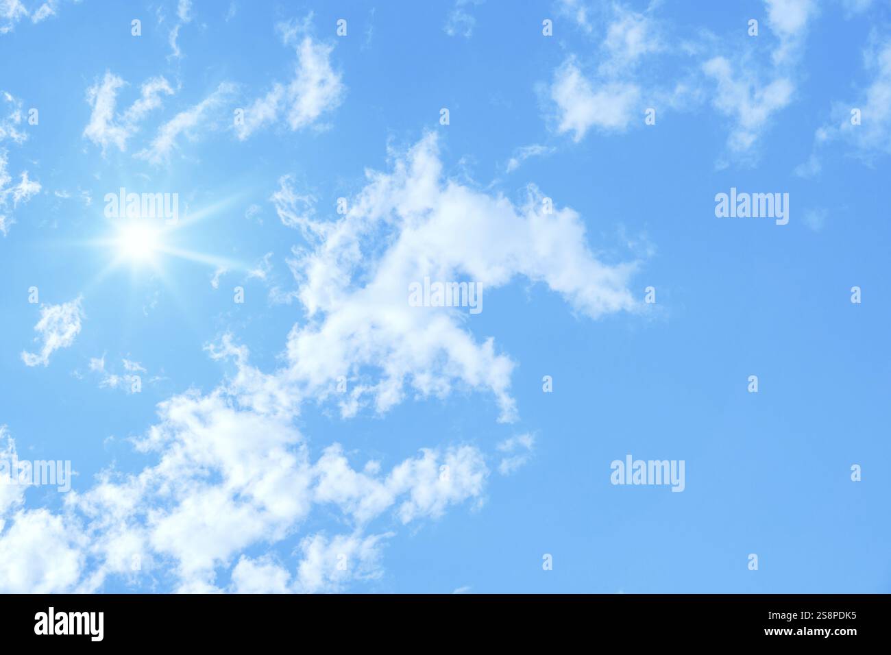 An image of a typical blue sky with sun and clouds background Stock ...