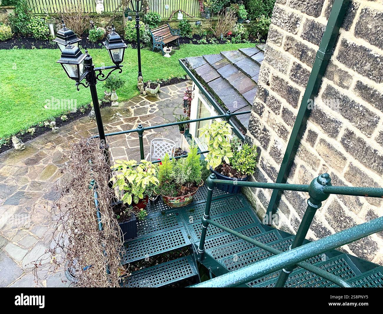 Garden lights steps Victorian style type place plants plant green metal old fashioned stone features path ornaments ornament climb climbing place lamp - Smartphone Captured Stock Image