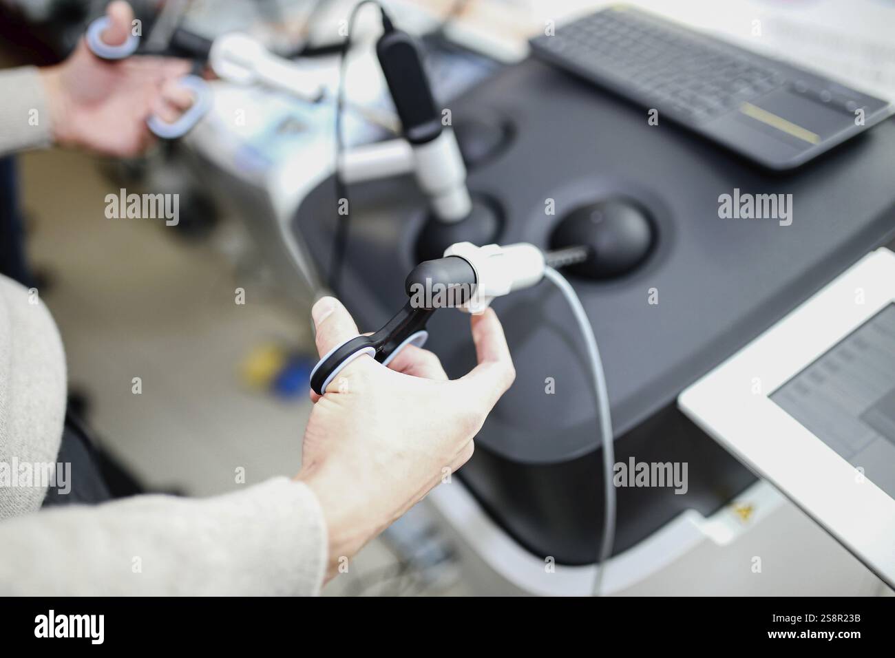 Hands interacting with a medical device operating controls Stock Photo ...
