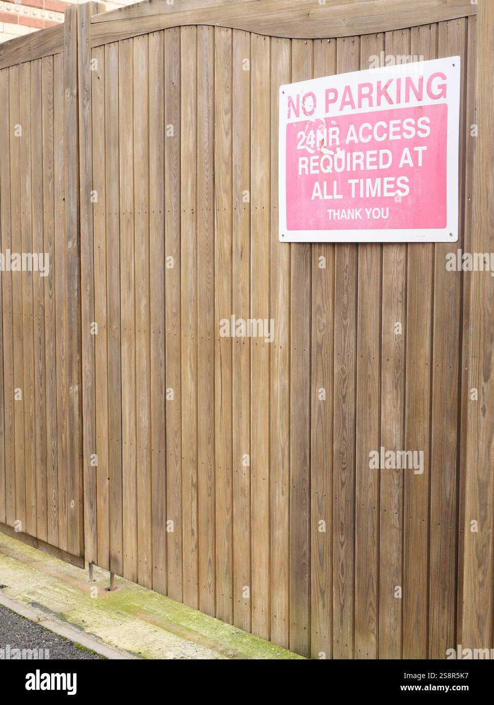 No Parking Access Required At All Times Sign On A Wooden Gate Entrance no-parking-access-required-at-all-times-sign-on-a-wooden-gate-entrance