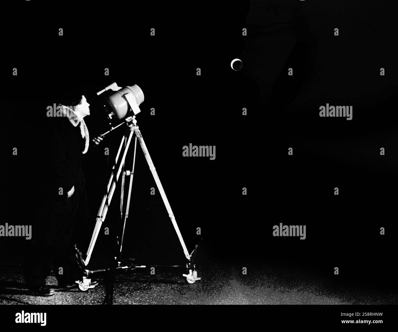 Photograph of an astronomer using a Barnes Engineering Company ...
