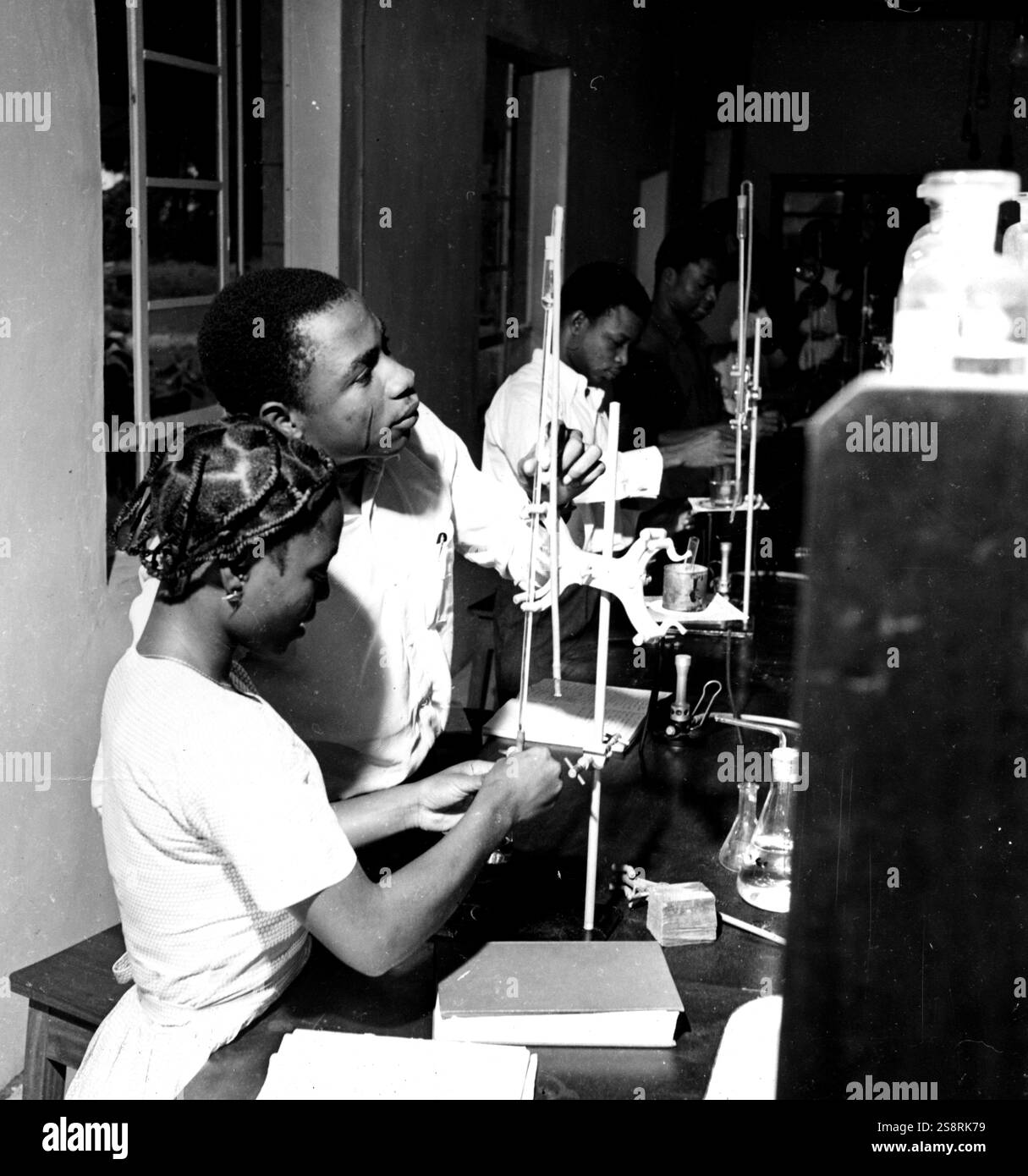 Photograph showing West African scientist using apparatus for chemical ...