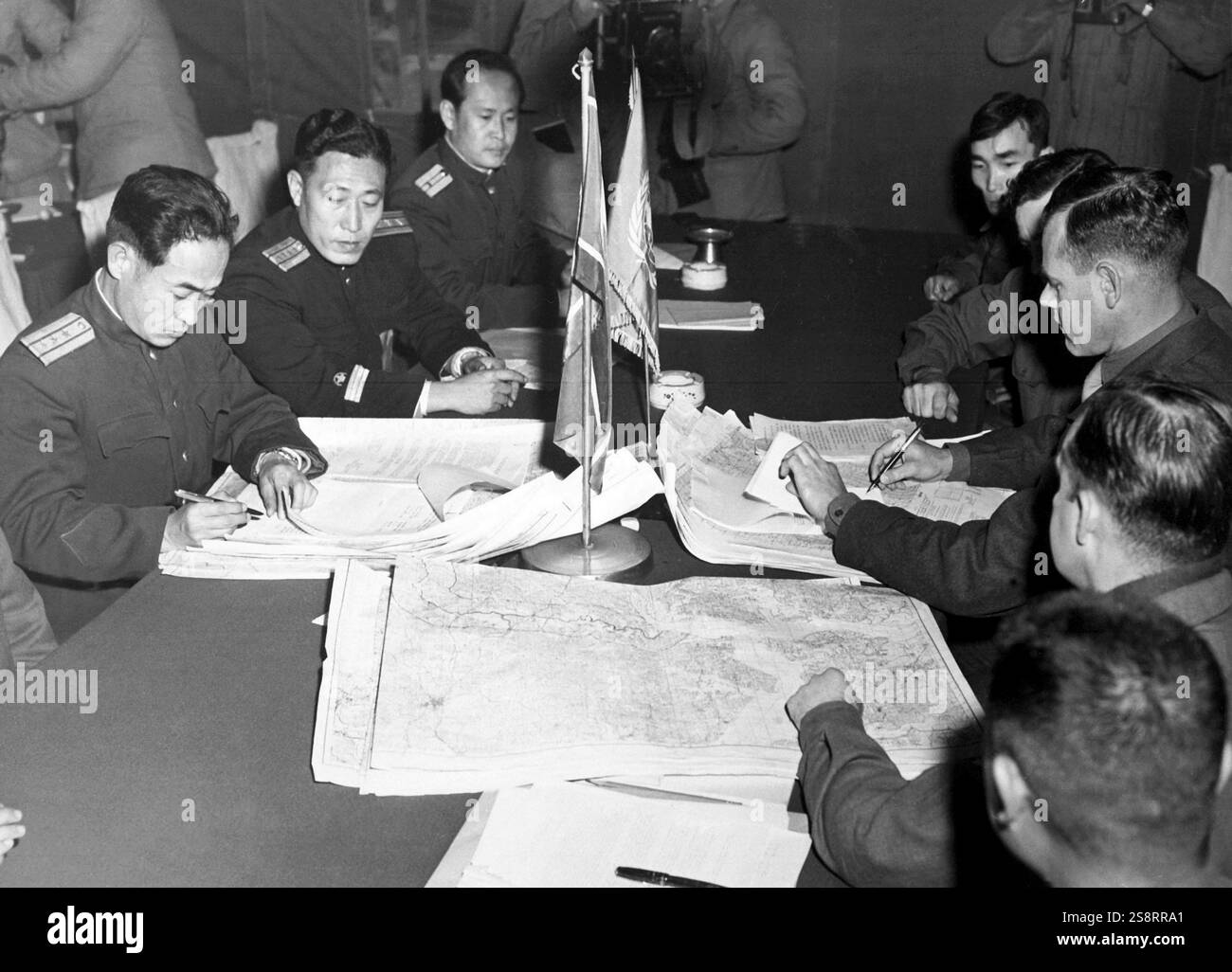 Col. James Murray, Jr., USMC, and Col. Chang Chun San, of the North Korean Communist Army, initial maps showing the north and south boundaries of the demarcation zone, during the Panmunjom cease fire talks. October 11, 1951 Stock Photo