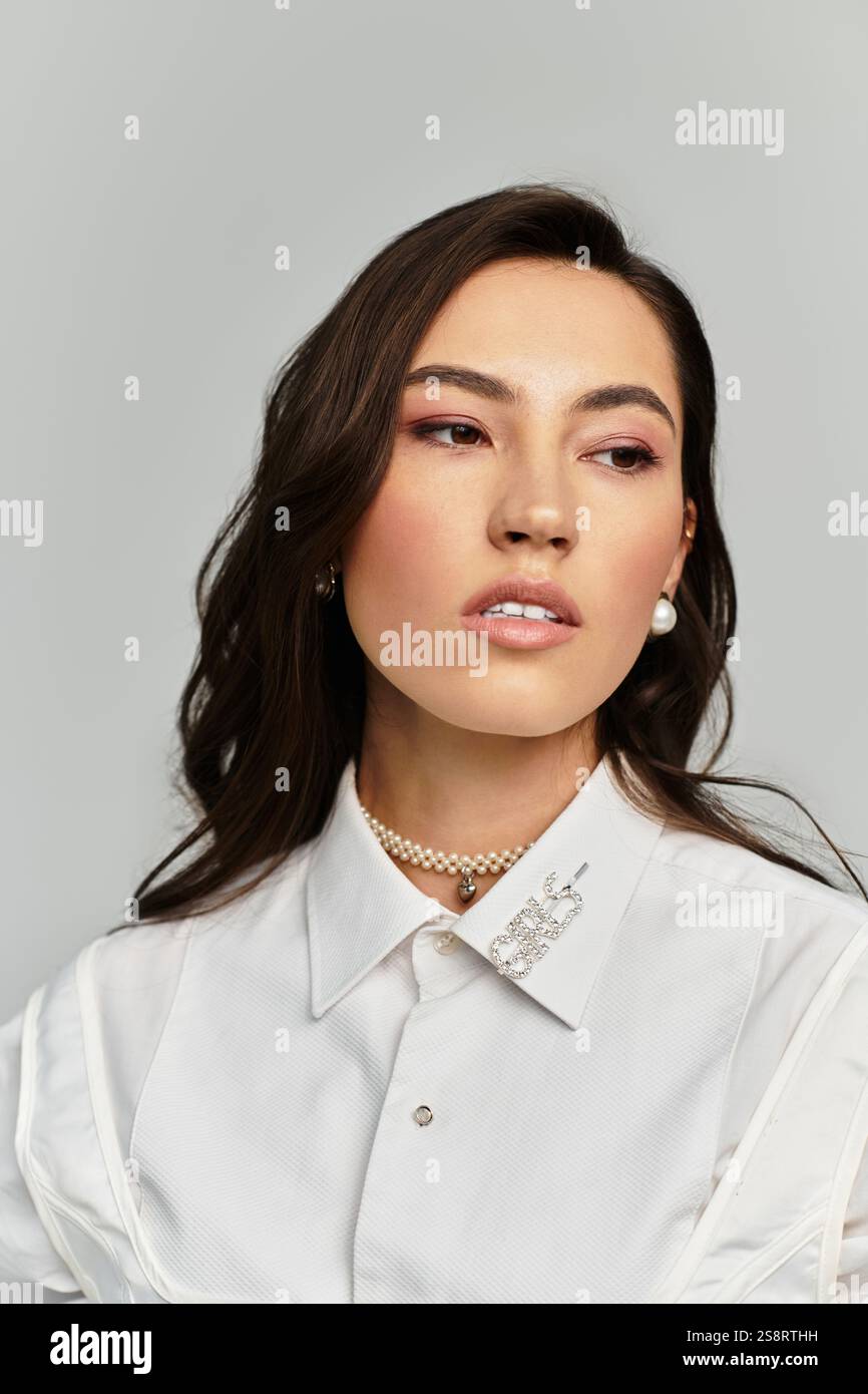 A stylish young woman poses gracefully, showcasing elegance in her ...