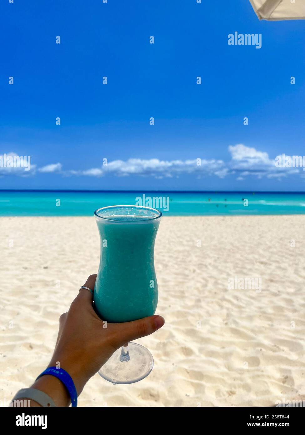 Drinking a Hawaiian blue at Cancun beach - Smartphone Captured Stock Image