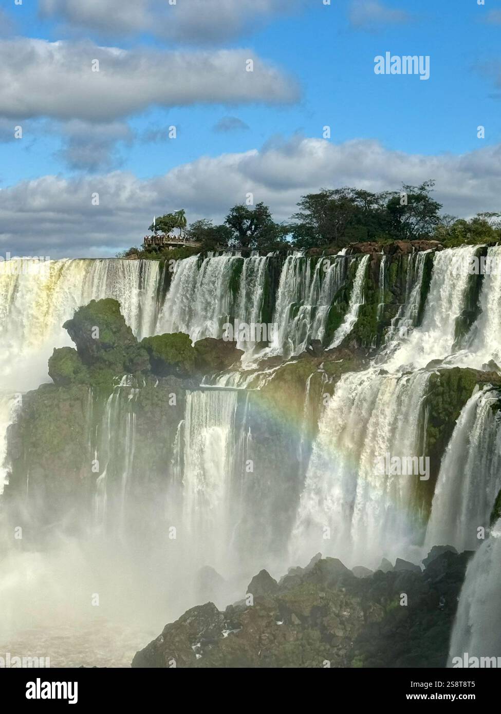 Rainbow over Iguazu Falls on a bright day - Smartphone Captured Stock Image
