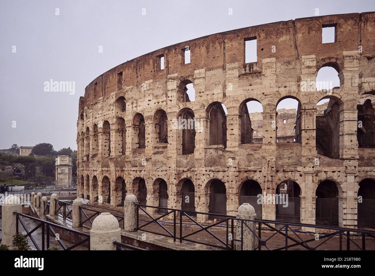 The Colosseum in Rome on a cloudy day, showcasing its iconic arches and ...