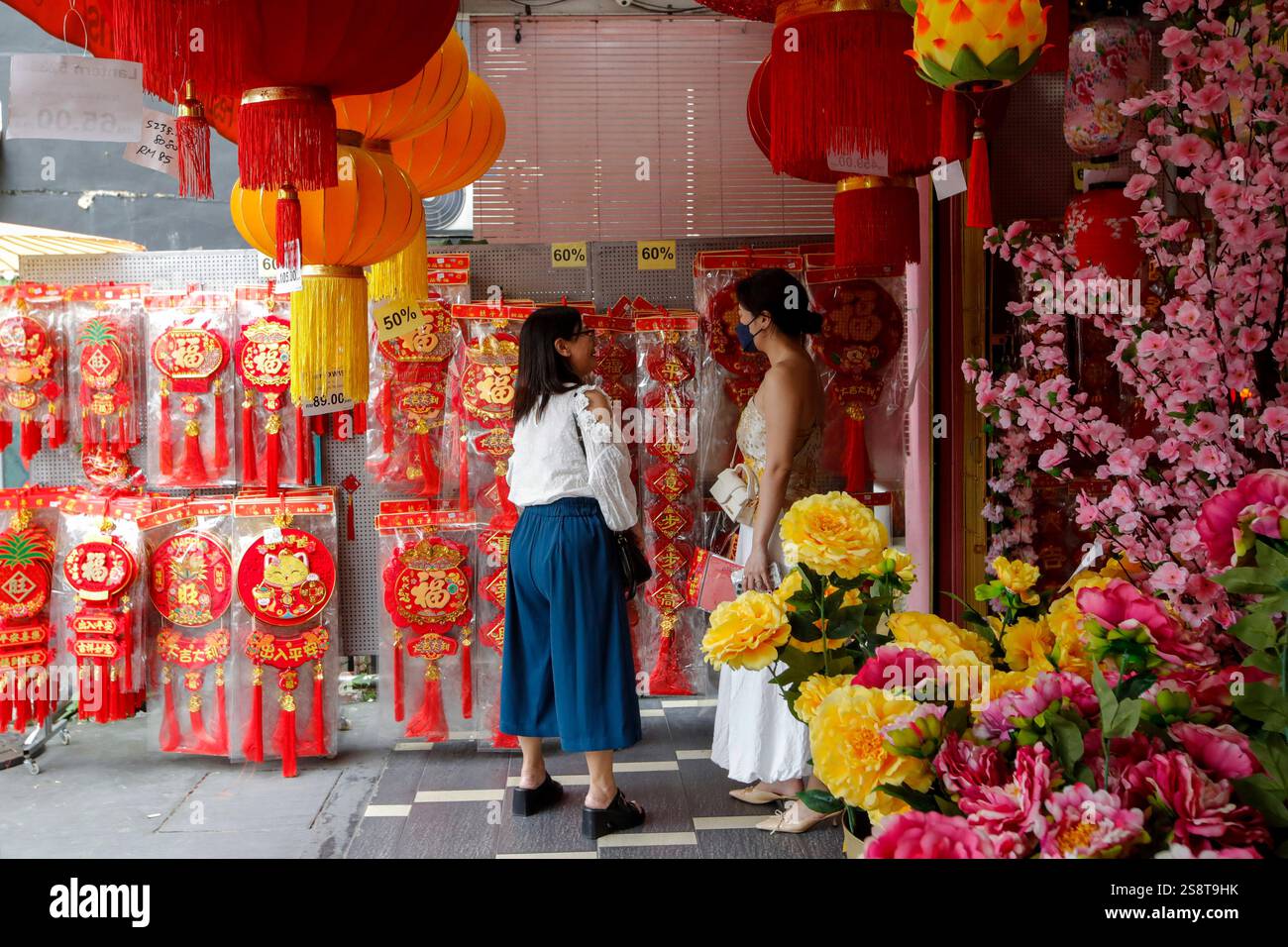 Ethnic Chinese women shop for Chinese New Year decorations ahead of the