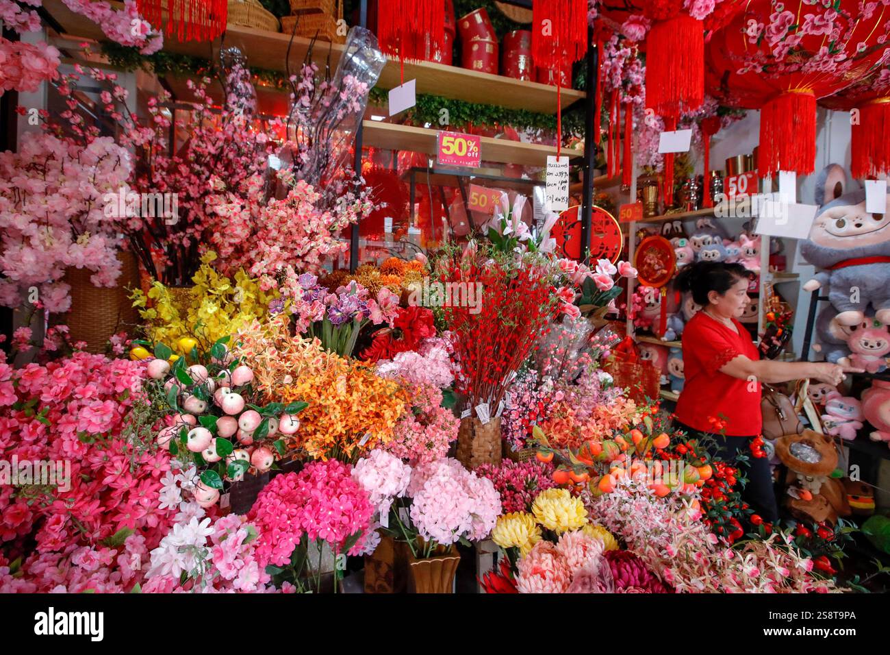 An ethnic Chinese woman shops for Chinese New Year decorations ahead of