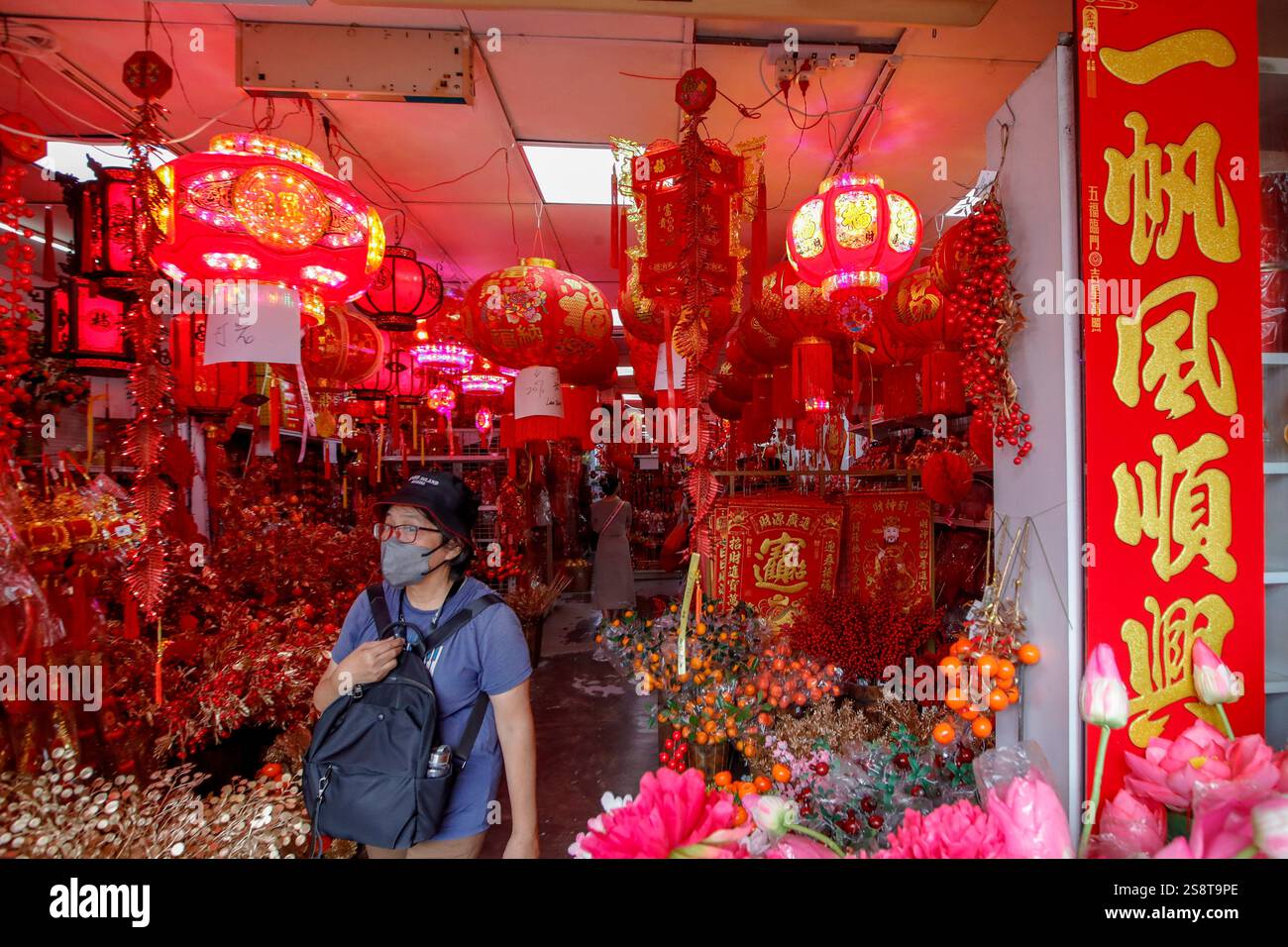 An ethnic Chinese woman shops for Chinese New Year decorations ahead of